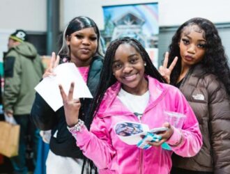 African American women, smiling and posing for the camera.