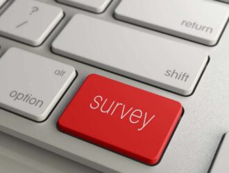 Close up of keyboard with a red survey button.